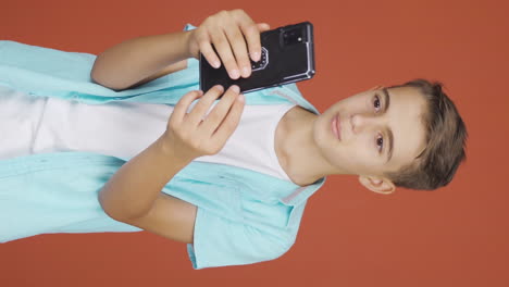 Vertical-video-of-Boy-making-a-video-call-on-the-phone.